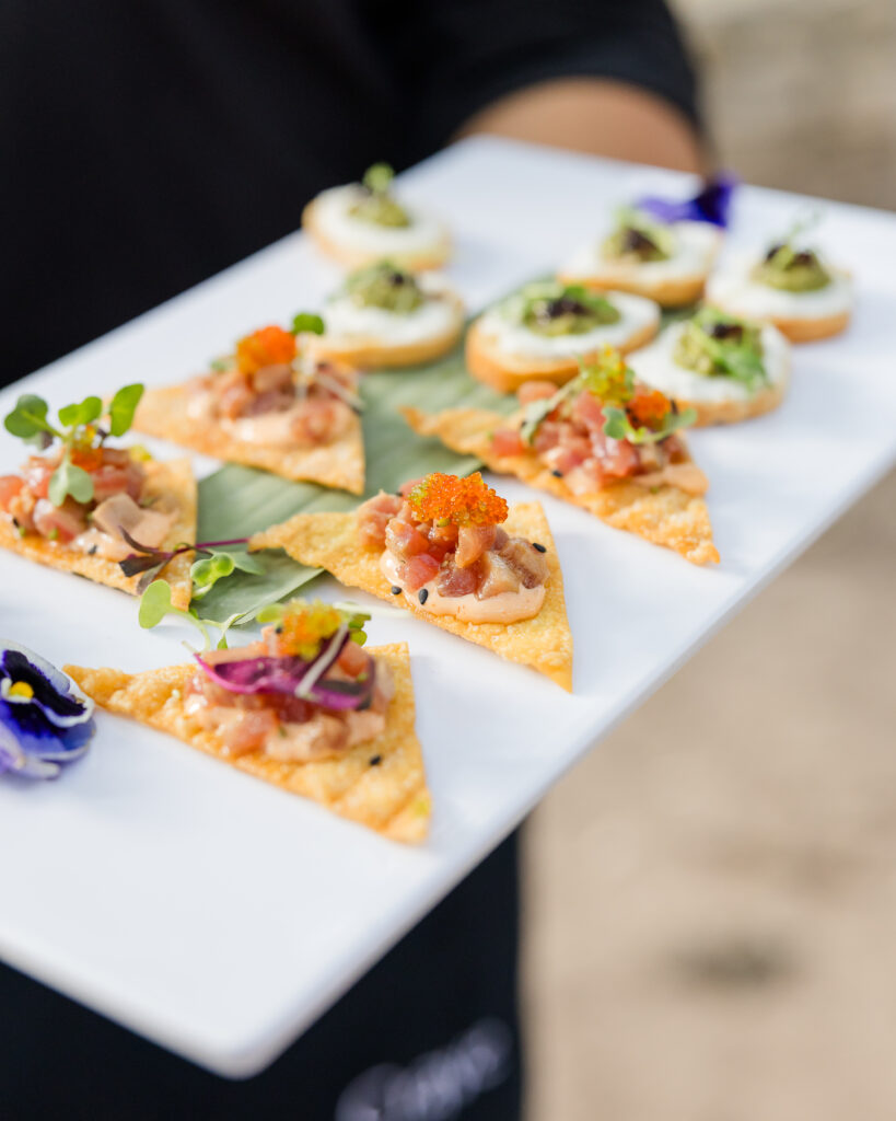 Passed ahi tuna tartare canap&eacute;s on a white tray at a Rhinory reception